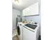 Functional laundry room with modern washer and dryer, overhead storage, and a water heater at 20845 Summit Rd, Noblesville, IN 46062