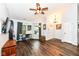 A spacious living room with wood floors, a ceiling fan, and a door leading to the outside at 20845 Summit Rd, Noblesville, IN 46062