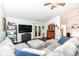 Living room with wood floors, vaulted ceilings, gray couch with ottomans, and view of back patio at 20845 Summit Rd, Noblesville, IN 46062