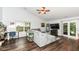Living room features wood floors, vaulted ceilings, and a cozy gray couch near the window and doors at 20845 Summit Rd, Noblesville, IN 46062