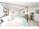 Bright main bedroom with large windows, canopy bed, accent chair, and decorative shelving at 20845 Summit Rd, Noblesville, IN 46062