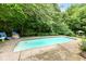 Backyard swimming pool surrounded by lush greenery, providing a private and refreshing outdoor oasis at 20845 Summit Rd, Noblesville, IN 46062