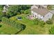 Aerial view of large landscaped backyard featuring a patio with seating, a fire pit, and a trampoline at 2096 Whitetail Ct, Avon, IN 46123
