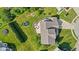 Aerial view of landscaped backyard featuring a patio with seating, a fire pit, and two trampolines at 2096 Whitetail Ct, Avon, IN 46123