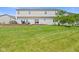 Large, green backyard features a retaining wall and patio with outdoor furniture at 2096 Whitetail Ct, Avon, IN 46123