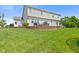 House backyard is a green lawn with a retaining wall and patio furniture at 2096 Whitetail Ct, Avon, IN 46123