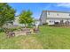 Backyard with a fire pit and chairs alongside a house with a patio area at 2096 Whitetail Ct, Avon, IN 46123