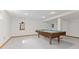 Basement game room features neutral floor, billiard table and natural wood trim at 2096 Whitetail Ct, Avon, IN 46123