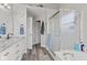 Modern bathroom with granite countertops, white cabinets, glass shower doors and wood look floors at 2096 Whitetail Ct, Avon, IN 46123