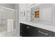 Well-lit bathroom with black vanity, white countertop and updated fixtures, shower-tub combination at 2096 Whitetail Ct, Avon, IN 46123
