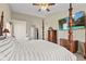 Bright bedroom showcasing a four-poster bed, carpet, and a vanity with plentiful daylight at 2096 Whitetail Ct, Avon, IN 46123