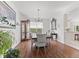 Charming dining area boasts hardwood floors, natural light, an antique cabinet and a chandelier at 2096 Whitetail Ct, Avon, IN 46123
