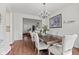 Elegant dining room featuring a wooden table, six chairs, chandelier, and a large, decorative painting at 2096 Whitetail Ct, Avon, IN 46123