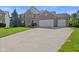 Charming two-story brick home with a well-manicured lawn and a spacious three-car garage at 2096 Whitetail Ct, Avon, IN 46123