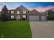 Charming two-story brick home with a well-manicured lawn and a spacious three-car garage at 2096 Whitetail Ct, Avon, IN 46123