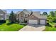 Charming two-story brick home with a well-manicured lawn and a spacious three-car garage at 2096 Whitetail Ct, Avon, IN 46123