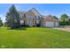 Well maintained lawn in front of a charming two-story brick home with a spacious three-car garage at 2096 Whitetail Ct, Avon, IN 46123