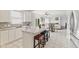 Open kitchen with bar seating flowing into living room area, stainless steel appliances, and recessed lighting at 2096 Whitetail Ct, Avon, IN 46123