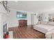 Cozy living room with fireplace, hardwood floors, and large TV, perfect for relaxing at 2096 Whitetail Ct, Avon, IN 46123