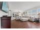 Bright living room with hardwood floors, sectional sofa, and open layout leading to the kitchen at 2096 Whitetail Ct, Avon, IN 46123