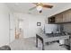 Office with a built-in desk, ceiling fan, and a view of the hallway and staircase at 2096 Whitetail Ct, Avon, IN 46123
