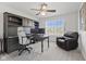 Office with a built-in desk, ceiling fan, an ergonomic chair, and a comfortable brown leather recliner at 2096 Whitetail Ct, Avon, IN 46123
