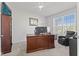 Bright office features natural light, neutral color palette, and includes an accent chair at 2096 Whitetail Ct, Avon, IN 46123