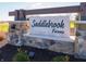 Elegant entrance sign for Saddlebrook Farms, featuring stone pillars and manicured landscaping at 210 Ames Dr, Whiteland, IN 46184