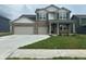 Charming two-story home featuring a two-car garage and well-manicured front yard at 210 Ames Dr, Whiteland, IN 46184