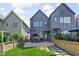 Contemporary home's backyard with a patio, modern fencing, and a lush green lawn at 2140 Alabama St, Indianapolis, IN 46202