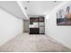 Functional kitchenette area in the basement with stainless steel refrigerator and dark cabinetry at 2140 Alabama St, Indianapolis, IN 46202
