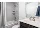 Bathroom with gray tiled shower and tub combo, and vanity with white sink at 2140 Alabama St, Indianapolis, IN 46202