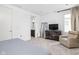 Spacious bedroom features a relaxing chair, TV and dresser and ensuite bath at 2140 Alabama St, Indianapolis, IN 46202