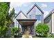 Modern two-story home featuring a covered porch and professional landscaping at 2140 Alabama St, Indianapolis, IN 46202