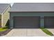 Garage exterior view with a paved driveway, two doors, and exterior lighting at 2140 Alabama St, Indianapolis, IN 46202