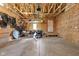 Spacious garage with an open ceiling featuring exposed framing, storage space, and a concrete floor at 2140 Alabama St, Indianapolis, IN 46202