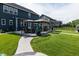 Beautifully landscaped backyard with a winding walkway, outdoor dining area, and lush green lawn at 2245 Meadow Crk, Avon, IN 46123
