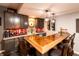 Finished basement bar with granite counters, wooden bar top, and stone accents at 2245 Meadow Crk, Avon, IN 46123