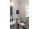 Charming powder room with stylish fixtures, a pedestal sink, and a framed mirror at 2245 Meadow Crk, Avon, IN 46123