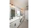 Bright bathroom featuring a double vanity with white countertops, modern fixtures, and wood-look tile flooring at 2245 Meadow Crk, Avon, IN 46123