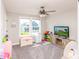Inviting playroom with natural light, a ceiling fan, and organized toy storage creating a cheerful space at 2245 Meadow Crk, Avon, IN 46123