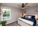 Relaxing bedroom with a backyard view, ceiling fan, and stylish, comfortable furnishings at 2245 Meadow Crk, Avon, IN 46123