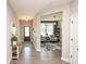 Bright and inviting entryway with hardwood floors, stylish decor, and a glimpse into the adjacent living area at 2245 Meadow Crk, Avon, IN 46123