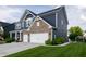 Stylish two-story home with blue siding, brick accents, and a well-kept lawn leading to a spacious two-car garage at 2245 Meadow Crk, Avon, IN 46123