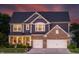 Charming two-story home with brick and blue facade, enhanced by warm lighting and a well-maintained lawn at 2245 Meadow Crk, Avon, IN 46123
