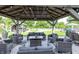 Well-appointed gazebo with comfortable seating, stylish decor, and a view of the pool and yard at 2245 Meadow Crk, Avon, IN 46123