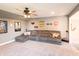 Relaxing home theater featuring a large sectional sofa, TV, and ceiling fan at 2245 Meadow Crk, Avon, IN 46123
