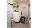 Efficient laundry room with washer, dryer, storage, and stylish laundry mat at 2245 Meadow Crk, Avon, IN 46123