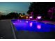 Inviting swimming pool with illuminated fountains, palm trees, and modern landscaping at 2245 Meadow Crk, Avon, IN 46123