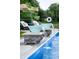 Beautiful pool with cascading water features, lounge chairs, and tropical accents for a relaxing outdoor experience at 2245 Meadow Crk, Avon, IN 46123